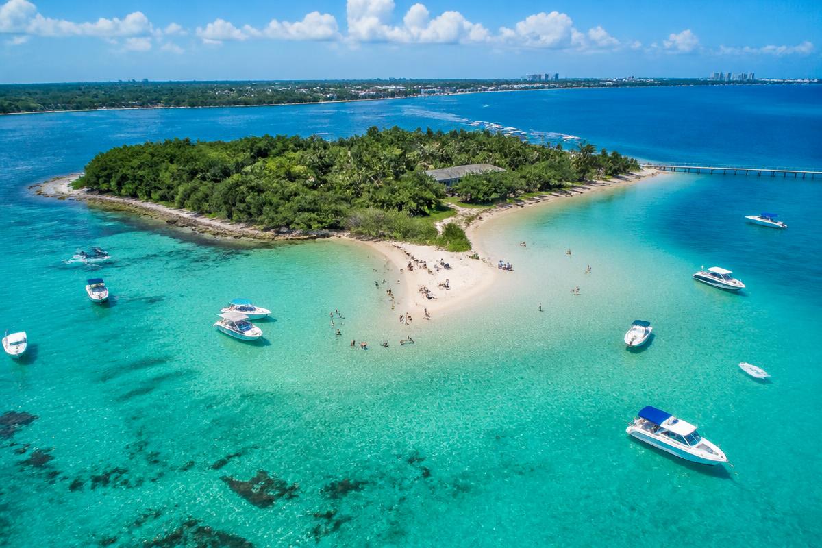 Aerial view of Peanut Island with turquoise water and anchored boats